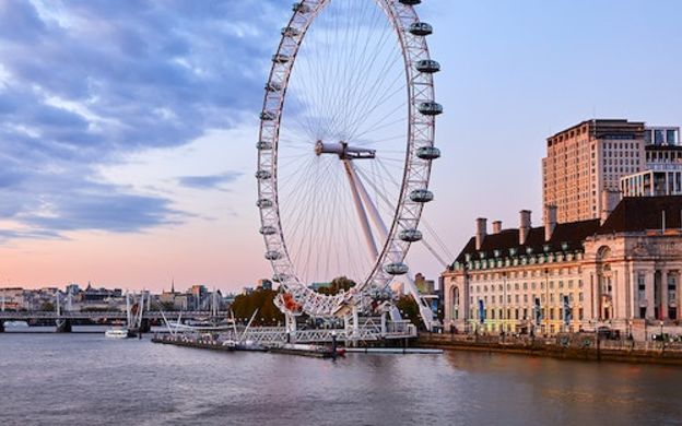 Breathtaking sunset view of Thames River and Ferris Wheel, creating a picturesque scene of London's beauty and tranquility.